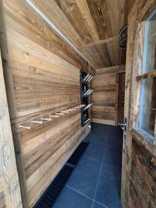 a sauna with wood paneled walls and tile floors at Chalet La Grange à Philippe in Evolène