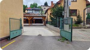 an entrance to a building with two green gates at Apartment LAURA in Žilina