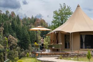 a man taking a picture of a tent at Saraaya Glamps, Dharamshala in Dharamshala