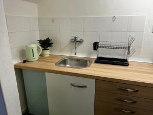 a kitchen counter top with a sink and a sink at NK House in Pero