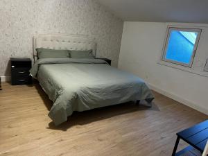 a bedroom with a large bed and a window at NK House in Pero