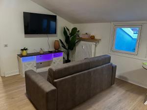 a living room with a couch and a flat screen tv at NK House in Pero