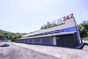 a building with a car parked in front of it at 김천747모텔 in Pusang