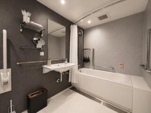 a bathroom with a sink and a bath tub and a sink at Randor Hotel Sapporo Heritage in Sapporo +56 photos