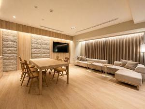 a living room with a table and a couch at Randor Hotel Sapporo Heritage in Sapporo