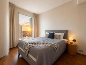 a bedroom with a large bed and a large window at 13th Floor Cityview Luxury in Tallinn