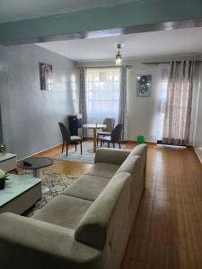 a living room with a couch and a table at Zariah Homes 2BR in Kakamega