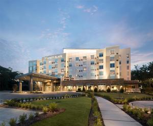 a hotel building with a lawn in front of it at Hyatt Place Biloxi in Biloxi