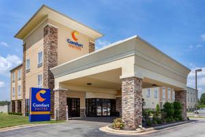 a hotel with a sign in front of a building at Comfort Suites Jonesboro University Area in Jonesboro