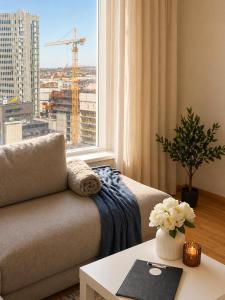 a living room with a couch and a large window at 13th Floor Cityview Luxury in Tallinn