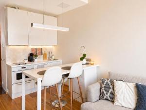 a kitchen with a table and chairs in a room at 13th Floor Cityview Luxury in Tallinn