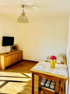 a living room with a table and a tv at Casa Marysol in Ventimiglia