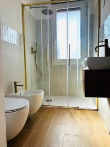 a bathroom with two sinks and a glass shower at Casa Marysol in Ventimiglia +29 photos