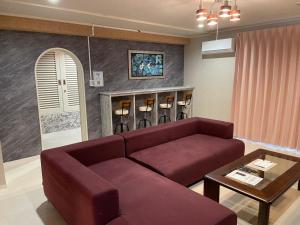 a living room with a couch and a table at ピンポンホテル Peace Park in Hiroshima