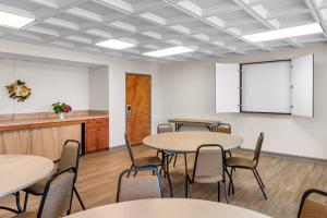 a classroom with tables and chairs and a white wall at Quality Suites Waldorf in Waldorf