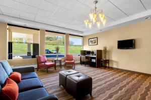 a living room with a couch and chairs and a tv at Comfort Inn Somerset in Somerset
