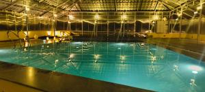 a large swimming pool in a large building at SPKA Jungle Resort in Vālpārai