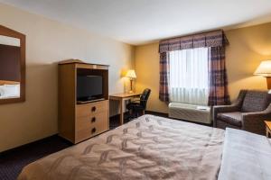 a hotel room with a bed and a television at Quality Inn Killeen Near Fort Hood in Killeen