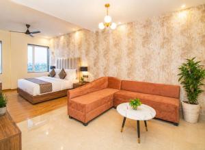 a living room with a couch and a bed at Hotel avadh classio near by ram mandir in Faizābād +24 photos