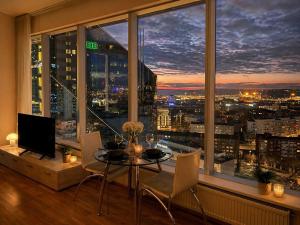 a room with a table and chairs and a large window at Panoramic Sea View -13th Floor in Tallinn