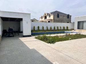 a backyard with a swimming pool and a house at Villa in Mayak in Baku