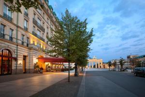 a tree on a street next to a building at Hotel Adlon Kempinski Berlin in Berlin