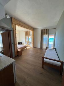 a room with two beds and a room with a kitchen at Molos Beach Rooms in Kissamos