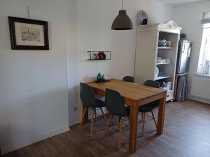 a dining room with a wooden table and chairs at Stadtapartement Geisa in Geisa