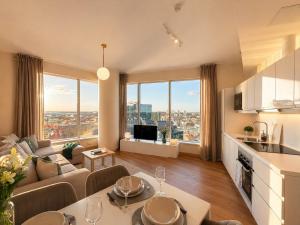 a living room with a couch and a table at Panoramic Sea View -11th Floor in Tallinn