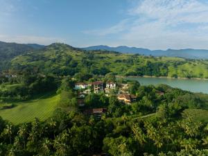 an aerial view of a house on a hill next to a river at Villa Subashri, Victoria Golf Greens - Digana in Kandy