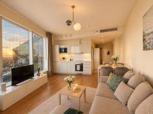 a living room with a couch and a large window at Panoramic Sea View -11th Floor in Tallinn +9 photos