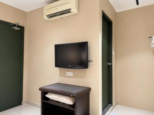 a room with a flat screen tv on the wall at Mansion Inn Sibu in Sibu +44 photos