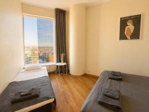 a bedroom with two beds and a large window at Panoramic Sea View -11th Floor in Tallinn