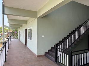 a hallway of a house with a staircase at Chippy Residency Coorg in Gonikoppal +4 photos