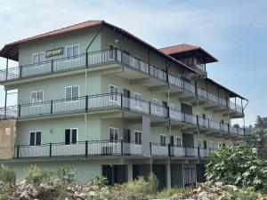 a building with balconies on the side of it at Chippy Residency Coorg in Gonikoppal
