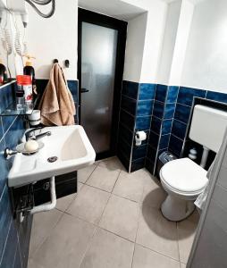 a bathroom with a sink and a toilet at OM Center Apartments Tirana in Tirana +17 photos