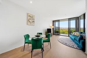 a living room with a couch and a table and chairs at Stylish 1-Bed in CBD with Secure Underground Parking in Canberra