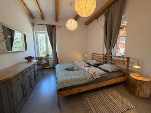 a bedroom with a bed and a desk in it at Siedlisko Dębinka in Miłomłyn