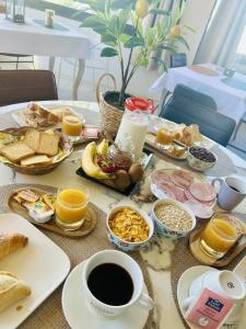 a table with breakfast foods and coffee on it at GABRIELLE HOTEL in Aiguines +88 photos