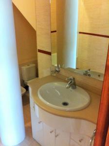 y baño con lavabo, espejo y aseo. en Apartamento Balcón de Europa 2A, en Nerja
