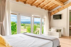 a bedroom with a bed and large windows at Agriturismo Relais Maddalene101 in Vicenza