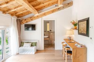 a room with white walls and a wooden table and chairs at Agriturismo Relais Maddalene101 in Vicenza