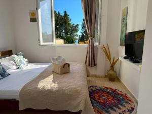 a bedroom with a bed with a bag on it at Apartments Lungo Mare Ulcinj in Ulcinj