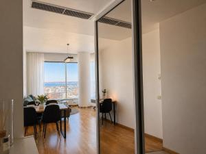 a dining room and living room with a table and chairs at Panoramic Sea View - 12th floor in Tallinn