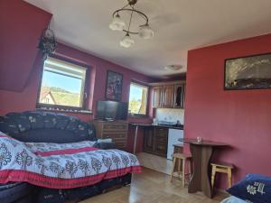 a living room with a bed and a kitchen at Endurance in Krośnica