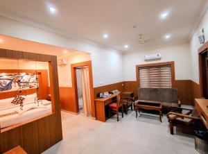 a room with a sink and a desk and a chair at Sneha Inn in Kannur +37 photos
