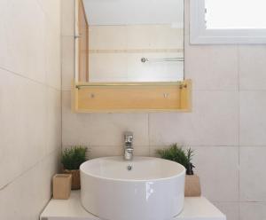 a bathroom with a white sink and a mirror at Apollo Sea Side Maisonette, Nikiti in Nikiti