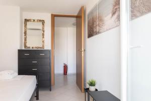 a bedroom with a bed and a mirror at Apollo Sea Side Maisonette, Nikiti in Nikiti