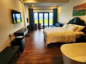 a hotel room with a bed and a television at Karst Residence Phong Nha in Phong Nha +47 photos