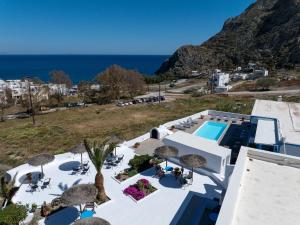 an aerial view of a resort with a swimming pool and the ocean at Ancient Thera Apartments in Kamari
